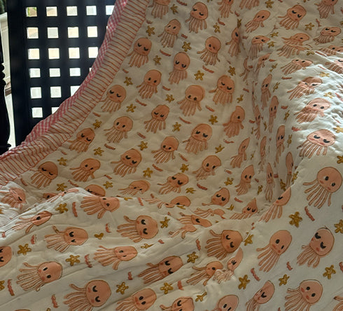 KalaIndia Jellyfish Friends Baby Quilt (Orange) – baby quilts India (styled in a nursery/crib)