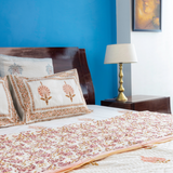 KalaIndia Peach Print Quilt – quilt blanket (styled on a bed)